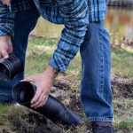 man installing a french drain