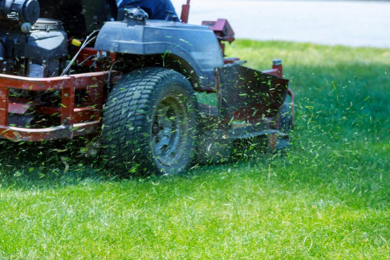 commercial lawn mower mowing the grass