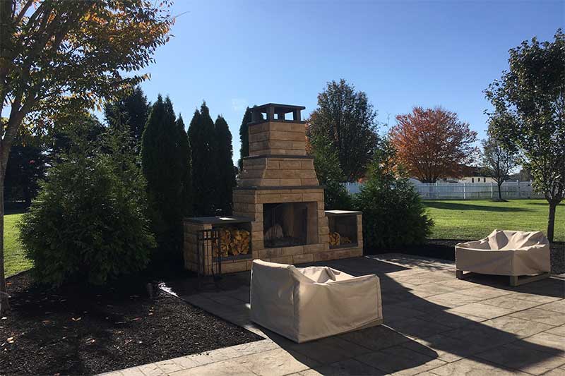 outdoor fireplace and patio with chairs