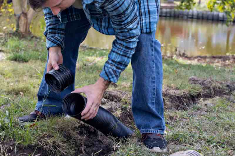 man installing a french drain