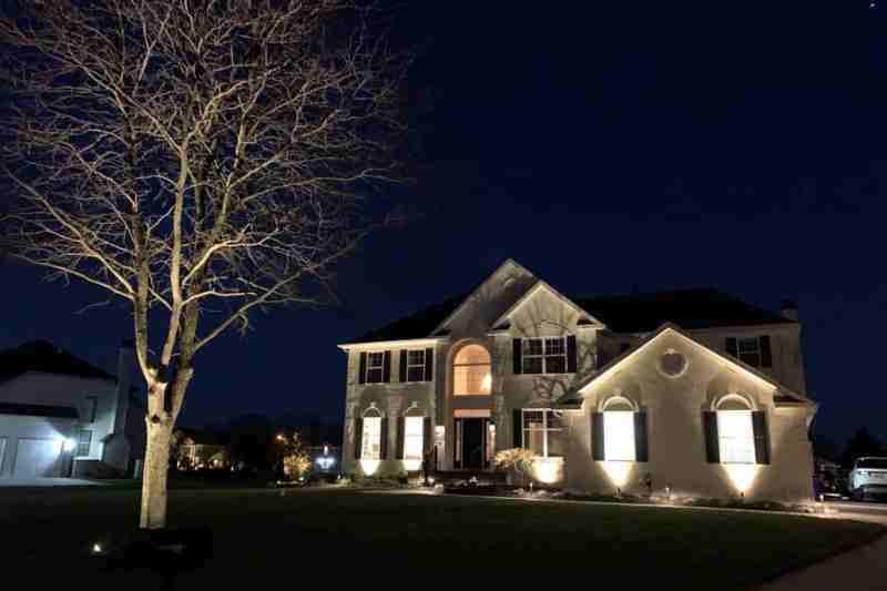 front of a home with outdoor lighting