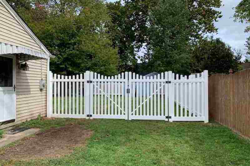 white vinyl fence leading to backyard